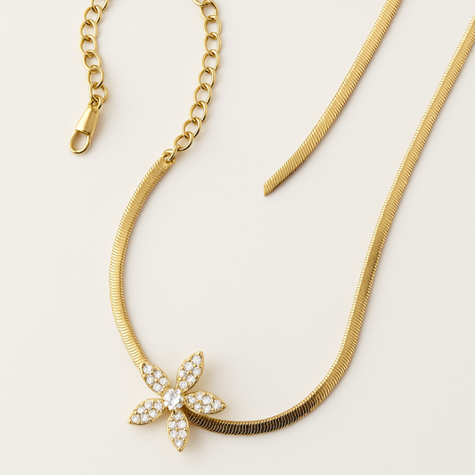 Gold necklace with a starfish pendant on a light background